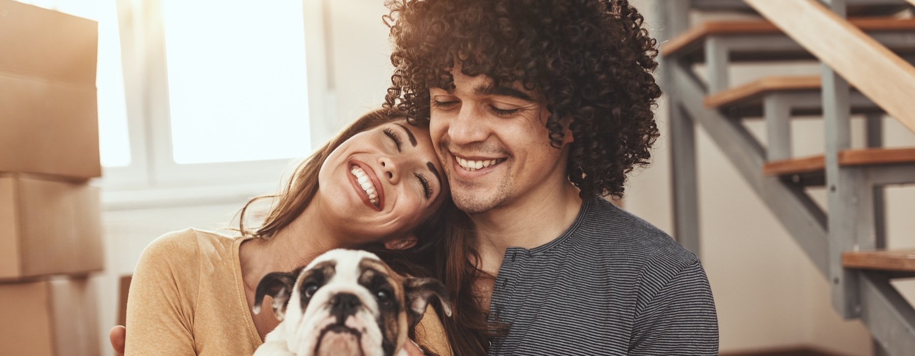 a man and woman holding a dog